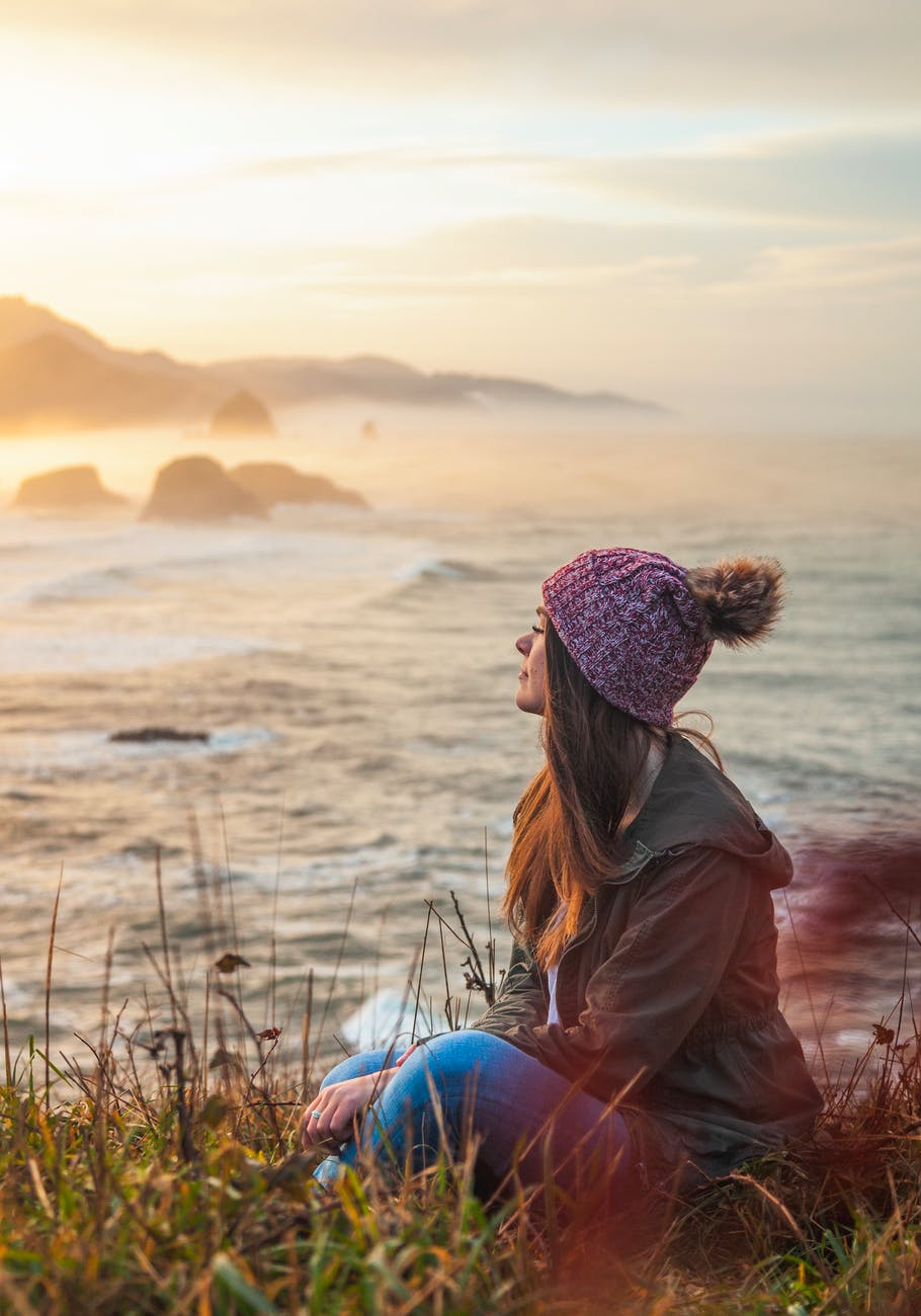 woman sitting by the cliff